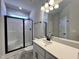 Bathroom with a glass-enclosed shower and black hardware at 20 S Mistflower St, Clayton, NC 27520