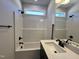 Bathroom features a modern shower/tub, black fixtures and a light stone countertop at 20 S Mistflower St, Clayton, NC 27520