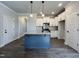 Bright kitchen with granite island, stainless steel appliances and white cabinetry at 20 S Mistflower St, Clayton, NC 27520