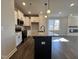 Kitchen features an island with granite countertops, stainless steel appliances, and a sink at 20 S Mistflower St, Clayton, NC 27520