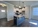 Modern kitchen with granite island, stainless steel appliances and hardwood flooring at 20 S Mistflower St, Clayton, NC 27520