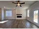 Living room features wood flooring, a modern fireplace, and large windows at 20 S Mistflower St, Clayton, NC 27520