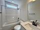 Bright bathroom features a shower-tub combination and a modern vanity with a quartz countertop and matte black faucet at 23 S Mistflower St, Clayton, NC 27520