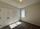 Bedroom featuring a double door closet and window offering natural light at 23 S Mistflower St, Clayton, NC 27520