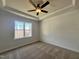 Bedroom featuring a ceiling fan, horizontal plank accent wall, and natural light at 23 S Mistflower St, Clayton, NC 27520