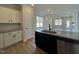 View of the kitchen island and open-concept living space with abundant natural light at 23 S Mistflower St, Clayton, NC 27520
