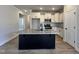 Kitchen featuring a central island, granite countertops, stainless steel appliances, and white cabinetry at 23 S Mistflower St, Clayton, NC 27520