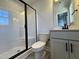 Modern bathroom featuring a glass-enclosed shower, toilet, and sleek vanity with black hardware at 232 Bluejay St, Clayton, NC 27520