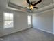 Spacious bedroom with carpet, a tray ceiling, two bright windows and neutral walls creating a peaceful retreat at 232 Bluejay St, Clayton, NC 27520