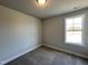 Comfortable bedroom offering plush carpeting, a window for natural light, and neutral paint creating a serene space at 232 Bluejay St, Clayton, NC 27520