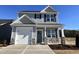 Charming two-story home with a combination of stone and gray siding, complemented by a two-car garage at 232 Bluejay St, Clayton, NC 27520