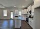 Spacious kitchen features white cabinets, stainless steel appliances, and a center island perfect for entertaining at 232 Bluejay St, Clayton, NC 27520