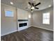 Inviting living room showcases a sleek electric fireplace, wood-look flooring, and ample natural light at 232 Bluejay St, Clayton, NC 27520