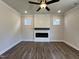 Open living room features a modern electric fireplace and wood-look flooring, creating a cozy and inviting atmosphere at 232 Bluejay St, Clayton, NC 27520