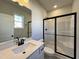 Contemporary bathroom with a quartz vanity, black hardware, and glass shower at 238 Bluejay St, Clayton, NC 27520