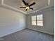 Comfortable bedroom with neutral carpet, modern trim, and a window with a peaceful outdoor view at 238 Bluejay St, Clayton, NC 27520