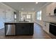 Open-concept kitchen with island, stainless steel dishwasher, and view to living area at 238 Bluejay St, Clayton, NC 27520