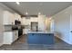 Modern kitchen with white cabinets, granite countertops, stainless steel appliances, and a blue island at 238 Bluejay St, Clayton, NC 27520