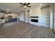 Open layout featuring kitchen with island that flows into living room with modern fireplace and shelves at 238 Bluejay St, Clayton, NC 27520
