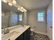 Modern bathroom with a double vanity, quartz countertops, and herringbone-patterned tile flooring at 24 S Mistflower St, Clayton, NC 27520
