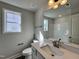 Well-lit bathroom featuring a large mirror, sink, and neutral color palette at 24 S Mistflower St, Clayton, NC 27520