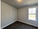 Bright bedroom with neutral carpet, large window offering natural light, and simple, clean design at 24 S Mistflower St, Clayton, NC 27520