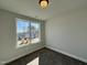 Well-lit bedroom with neutral walls, large windows providing ample natural light, and soft carpeting at 24 S Mistflower St, Clayton, NC 27520