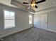 Serene bedroom with plush carpet, white shiplap walls, and large windows for natural light at 24 S Mistflower St, Clayton, NC 27520