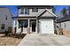 Charming two-story home featuring a two-car garage, stone accents, and manicured landscaping at 24 S Mistflower St, Clayton, NC 27520