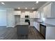 Modern kitchen with white cabinets, stainless steel appliances, granite countertops, and an island at 24 S Mistflower St, Clayton, NC 27520