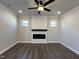 Cozy living room with dark wood flooring, a modern fireplace, and recessed lighting at 24 S Mistflower St, Clayton, NC 27520
