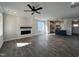 Bright living room with a fireplace, modern ceiling fan and open floor plan to the kitchen at 29 S Mistflower St, Clayton, NC 27520