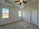 Spacious bedroom with neutral carpeting and large windows at 32 S Mistflower St, Clayton, NC 27520