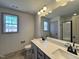 Modern bathroom with dual sinks, granite countertop, black hardware, and walk-in shower at 35 S Mistflower St, Clayton, NC 27520