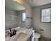 Well-lit bathroom with gray cabinets, modern fixtures, and large mirror at 35 S Mistflower St, Clayton, NC 27520
