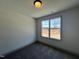 Inviting bedroom with carpeted flooring, large windows, and fresh neutral paint at 35 S Mistflower St, Clayton, NC 27520