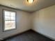An inviting room with carpeted flooring, large windows, and fresh neutral paint at 35 S Mistflower St, Clayton, NC 27520