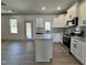 Bright kitchen with granite counters, an island, stainless appliances, and an adjacent dining area at 35 S Mistflower St, Clayton, NC 27520