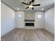 Living room featuring a modern fireplace, recessed lighting, and wood-look flooring at 35 S Mistflower St, Clayton, NC 27520