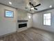 Spacious living room featuring a modern fireplace, recessed lighting, and wood-look flooring at 35 S Mistflower St, Clayton, NC 27520