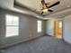 Main bedroom featuring a tray ceiling, ceiling fan, neutral paint, and carpeted flooring at 35 S Mistflower St, Clayton, NC 27520