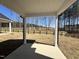 Covered patio overlooking spacious backyard with wooded views at 35 S Mistflower St, Clayton, NC 27520