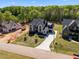 Aerial view of new construction home with a long drive and professionally landscaped yard at 65 Cherry Bark Dr, Youngsville, NC 27596