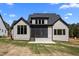 Rear exterior of home showcasing screened porch and spacious backyard at 65 Cherry Bark Dr, Youngsville, NC 27596