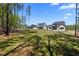Expansive backyard and the rear exterior of multiple new construction homes at 65 Cherry Bark Dr, Youngsville, NC 27596