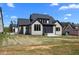 Back exterior view of house with a screened in porch and a newly seeded lawn at 65 Cherry Bark Dr, Youngsville, NC 27596