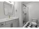 Modern bathroom featuring a glass shower, tile floor and white vanity at 65 Cherry Bark Dr, Youngsville, NC 27596