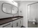Modern bathroom with gray vanity, quartz countertop, and stylish oval mirror at 65 Cherry Bark Dr, Youngsville, NC 27596