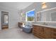Beautiful bathroom with standalone tub, dual sinks, and modern fixtures for a spa-like retreat at 65 Cherry Bark Dr, Youngsville, NC 27596