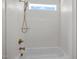 Well-lit bathroom featuring white tile and bronze fixtures, creating a clean, modern aesthetic at 65 Cherry Bark Dr, Youngsville, NC 27596